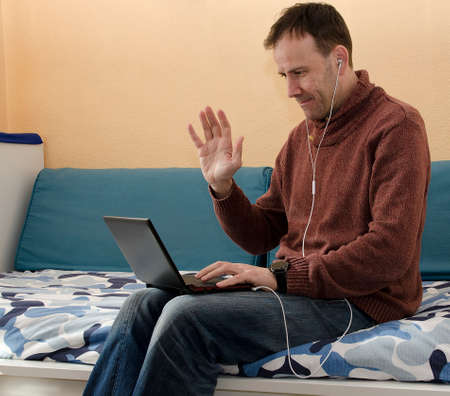 Businessman speaking on the phone and working with laptopの写真素材