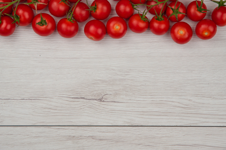 Tomatoes on the white tableの写真素材