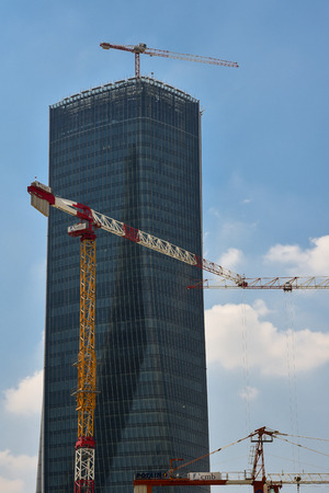 Crane construction equipment over builging construction site on blus sky background on day, technology transportation material to high site.のeditorial素材