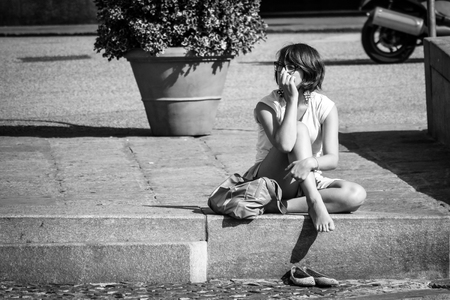 Genoa, Italy - August 02 2011: Girl relaxing in the city on a hot summer day. photo in black & white.のeditorial素材