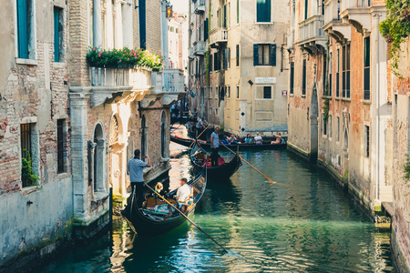 Venice, Italy - August 22 2018:  Traditional canal street with gondola in Venice, Italy.
