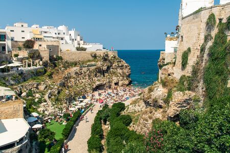 Polignano a mare, Italy - September 04 2019: Polignano a mare coast in Bari, Italy during summer with turquoise blue water in the sea.のeditorial素材