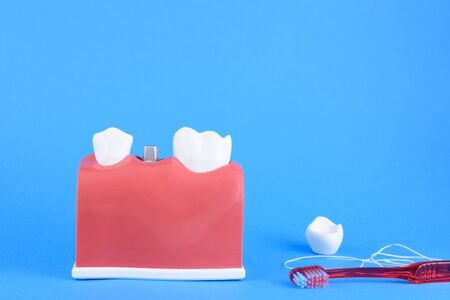 False mouth dentist in blue background with equipment for toothbrush