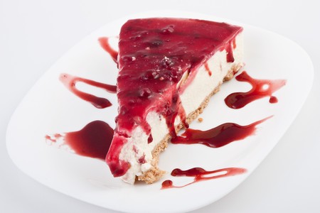 slice of trawberry cheesecake wtih topping on topの写真素材