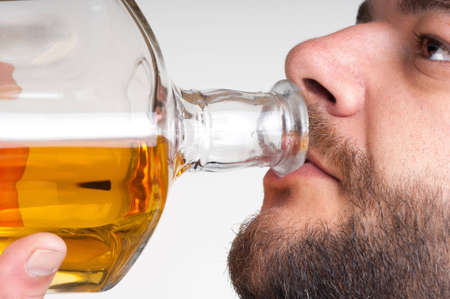 Drunk Businessman Drinking from a Bottle of whisky