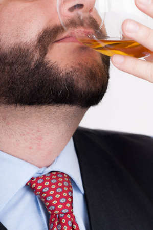 Drunk Businessman Drinking from a Bottle of whiskyの写真素材