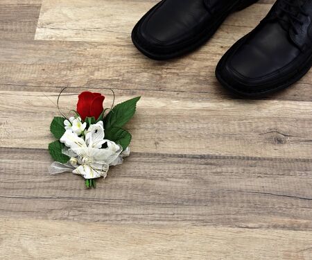 Black leather shoes and decoration on wooden floor
