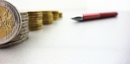 euro banknotes and coins on a gray background