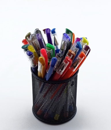 many colored pens on stand on a white backgroundの写真素材