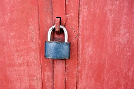 metal padlock on a metal doorの写真素材