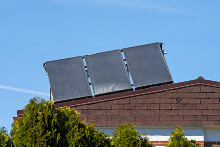 green energy, solar collectors on the roof of a family house