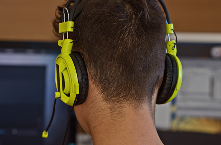 large headphones on a human's head in front of a PCの写真素材