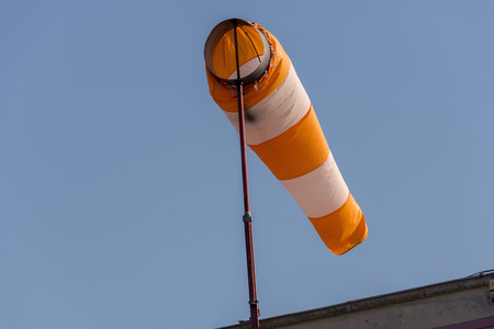 large wind direction indicator and blue skyの写真素材