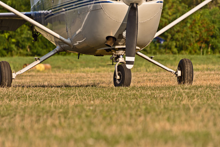 chassis of sport aircraft and green grass