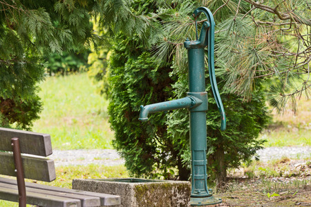 water well in the park between the treesの写真素材