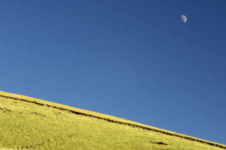 Meadow and moon in Pyrenees Mountains, Spainの写真素材