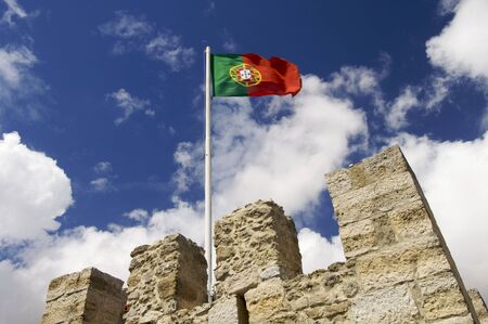 portugal flag on a mast located on a tower of the castle of St. George; Lisbonの写真素材