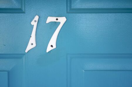 number seventeen nailed to a wooden door blue; Merced; California; Usaの写真素材