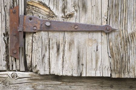 old and rusty hinge of a wood window; Biescas; Huesca; Aragon; Spain