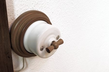 old light switch on a white wall
