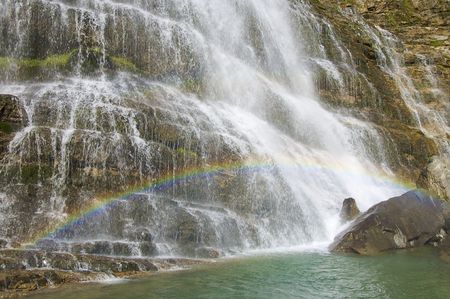 Rainbow in Cola de Caballo waterfall, Ordesa National Park, Pyrenees, Spainの写真素材