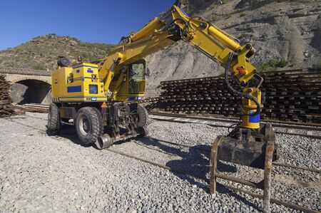 yellow machine repair train tracksの写真素材