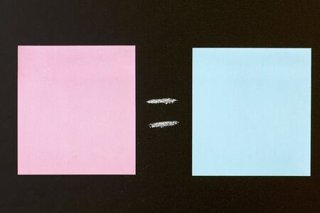 blue and pink paper in a blackboardの写真素材