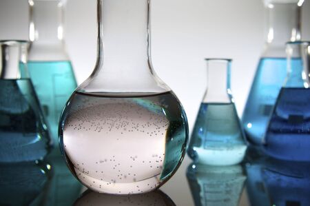 group of glass flasks with liquid in a laboratory