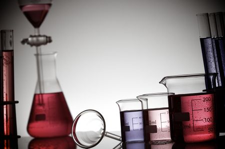 laboratory equipment with colored liquid on a white backgroundの写真素材