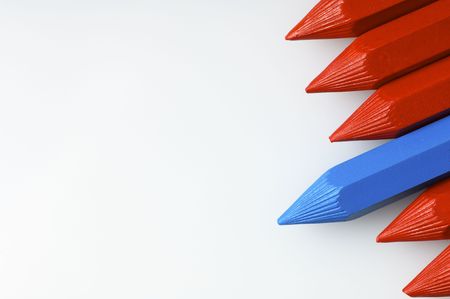 detail of some red pencils and blue on white paperの写真素材