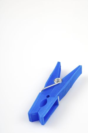 Blue cloth peg isolated in a white backgroundの写真素材