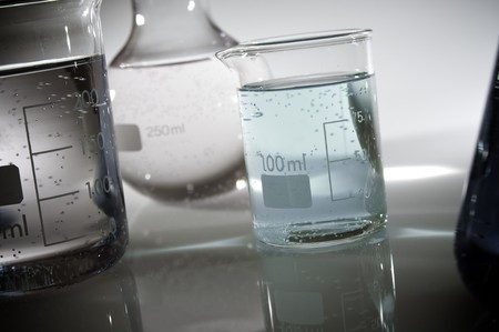 beakers backlit with white background in a laboratoryの写真素材