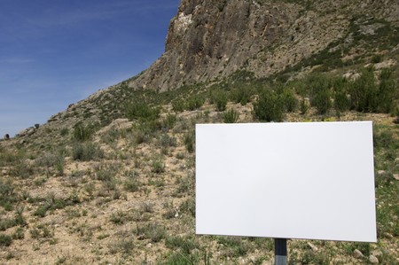 posted on an arid and  mountainous landscapeの写真素材