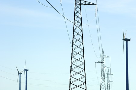 windmill and power line with blue and clear skyの写真素材