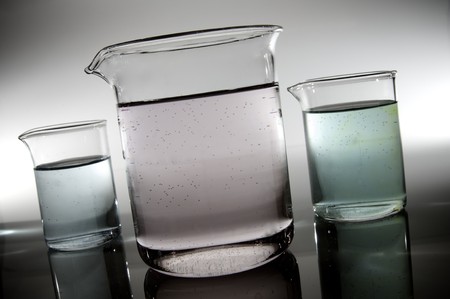 beakers backlit with white background in a laboratory