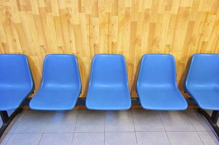 View of a group of blue plastic chairs linedの写真素材