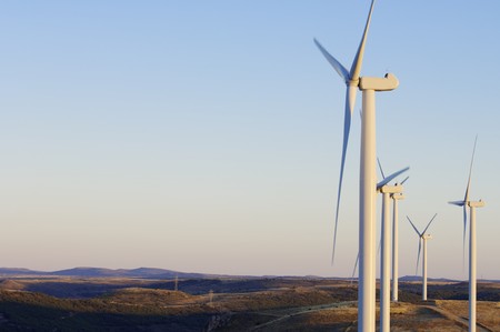 view at dusk of a group of modern windmills for electricity production