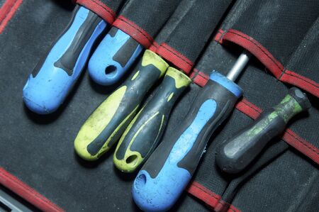 forefront of a group of blue and yellow screwdrivers