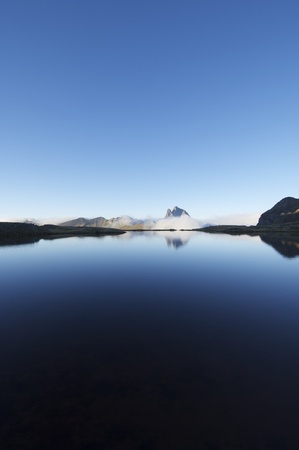 Midi Dossau peak view over a lake in the Pyreneesの写真素材