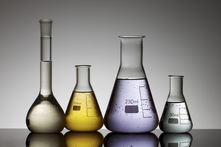 laboratory flasks with  brightly colored liquid insideの写真素材