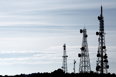 silhouette of  a group of telecommunication towers