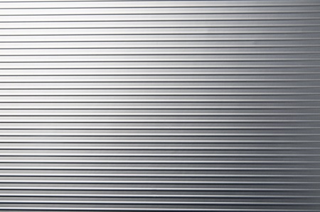 view of a  gray metal surface with regular  groovesの写真素材