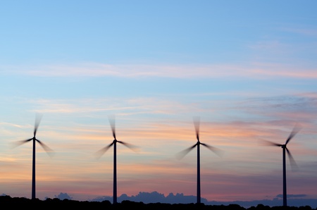 silhouette  of four windmills at  sunsetの写真素材