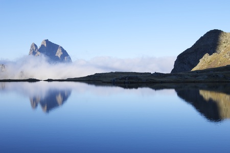 Midi Dossau peak view over a lake in the Pyreneesの写真素材