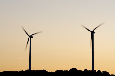 silhouette  of two windmills at  sunsetの写真素材
