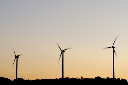 silhouette  of three windmills at  sunsetの写真素材