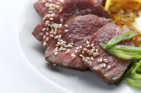 steak with  vegetable sauce and small seeds