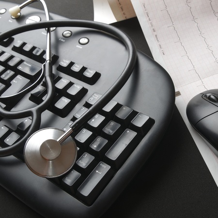 close up of a stethoscope and a computer keyboardの写真素材