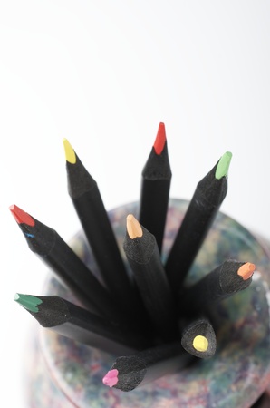 forefront of  a group of colored pencils  in a porcelain cupの写真素材