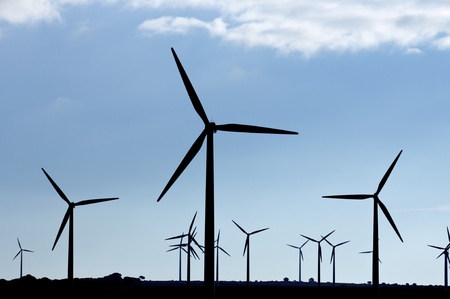 Backlit view of a group of mills for electric power generation